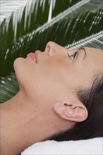 Woman lying on her back at spa.