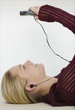 Woman listening to a portable music player.
