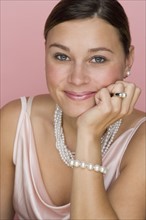 Studio shot of woman wearing pearls.