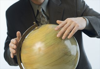 Man spinning a globe.
