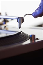 Person setting needle on a record.