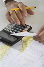 Close up of man using calculator.