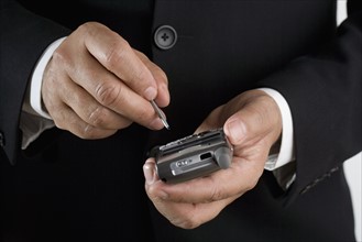 Close up of businessman using PDA.