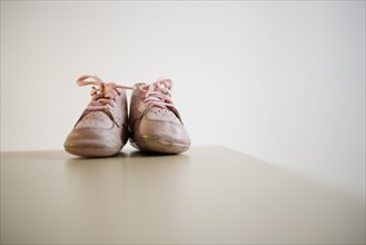 Pair of baby shoes on table.