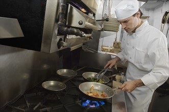 Male chef in restaurant kitchen.