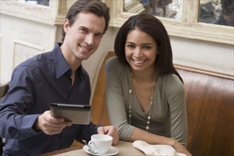 Couple paying bill at restaurant.