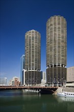 Marina City Towers with boat on Chicago River Chicago Illinois USA.