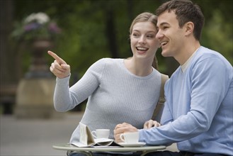 Couple having coffee at outdoor café.
