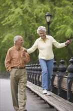 Senior couple walking in a park.