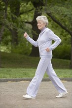 Senior woman power walking.