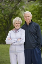 Portrait of senior couple in sweatsuits.