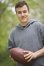 Portrait of man holding football.