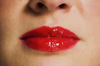 Close up of woman wearing red lipstick.