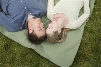 Young couple relaxing outdoors.