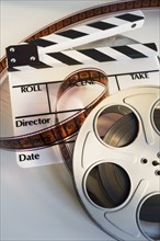 Movie reel with film and clapboard.
