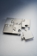 Metallic jigsaw puzzle.