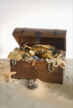 Wooden chest overflowing with treasure.