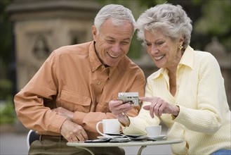 Senior couple having coffee at outdoor café.