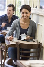 Woman having coffee at restaurant.