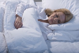 Senior woman sleeping in bed.