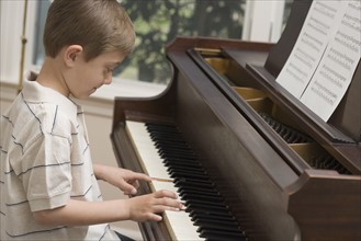 Young boy playing piano.