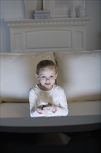 Young girl watching television .