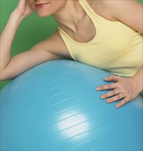 Woman working out with exercise ball.