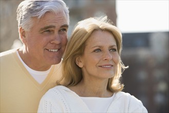 Senior couple smiling outdoors.