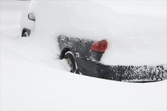 Car buried in snow in winter.
