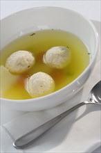 Close up of Matzah ball soup.