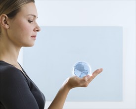 Woman holding small globe.
