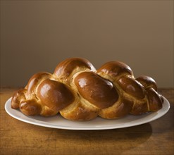 Loaf of Challah bread on platter.