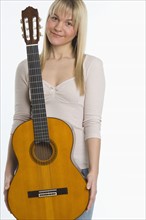 Studio shot of woman with guitar.
