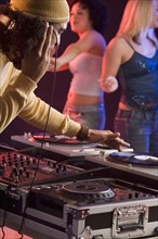 Young man playing music at a dance club.