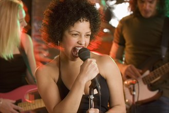 Woman singing with a band.