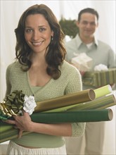 Couple with Christmas gifts and wrapping paper.