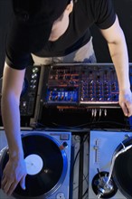 Man mixing music in a nightclub.