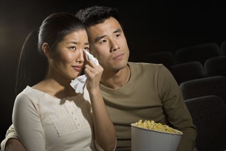Couple watching a sad movie.