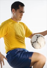 Man playing with soccer ball.
