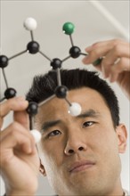 Scientist examining molecular structure.