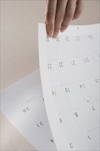 Woman paging through calendar.