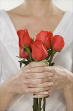 Woman holding bouquet of roses.
