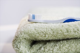 Close up of toothbrush on folded towel.