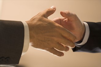 Closeup of men shaking hands.