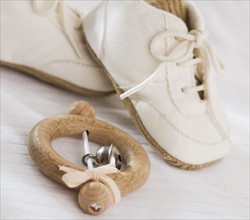Close up of baby rattle and baby shoes.