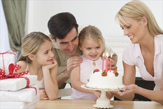 Girl celebrating birthday with family.