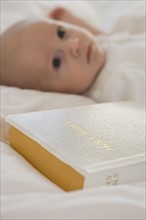 Close up of Bible next to baby.
