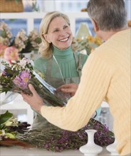 Female florist helping customer.