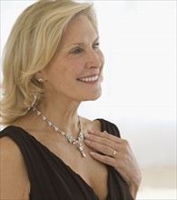 Senior woman wearing diamond necklace.