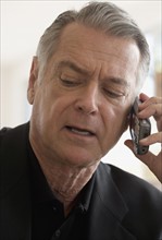 Senior businessman talking on cell phone.